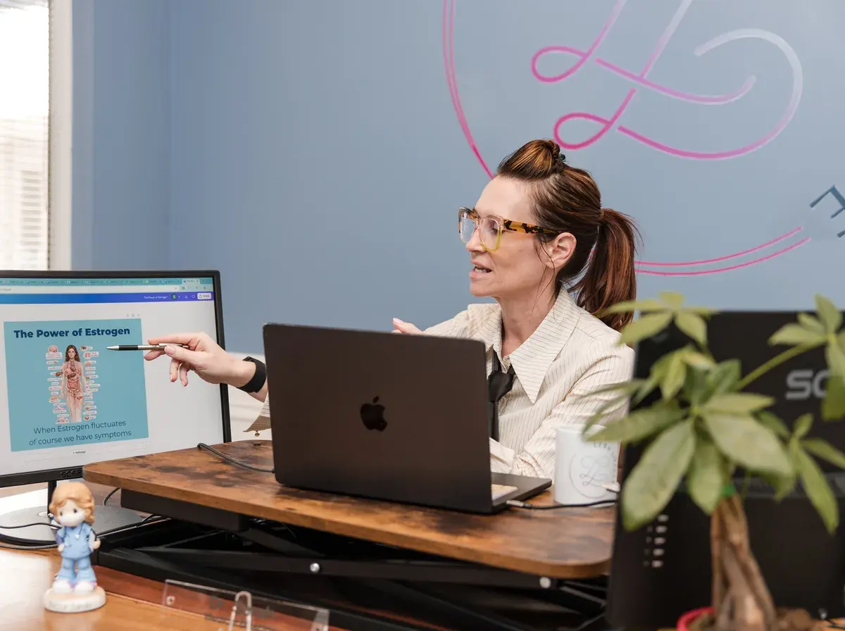 Dr. Sarah reviewing notes at her desk at Lesh Lifestyle
