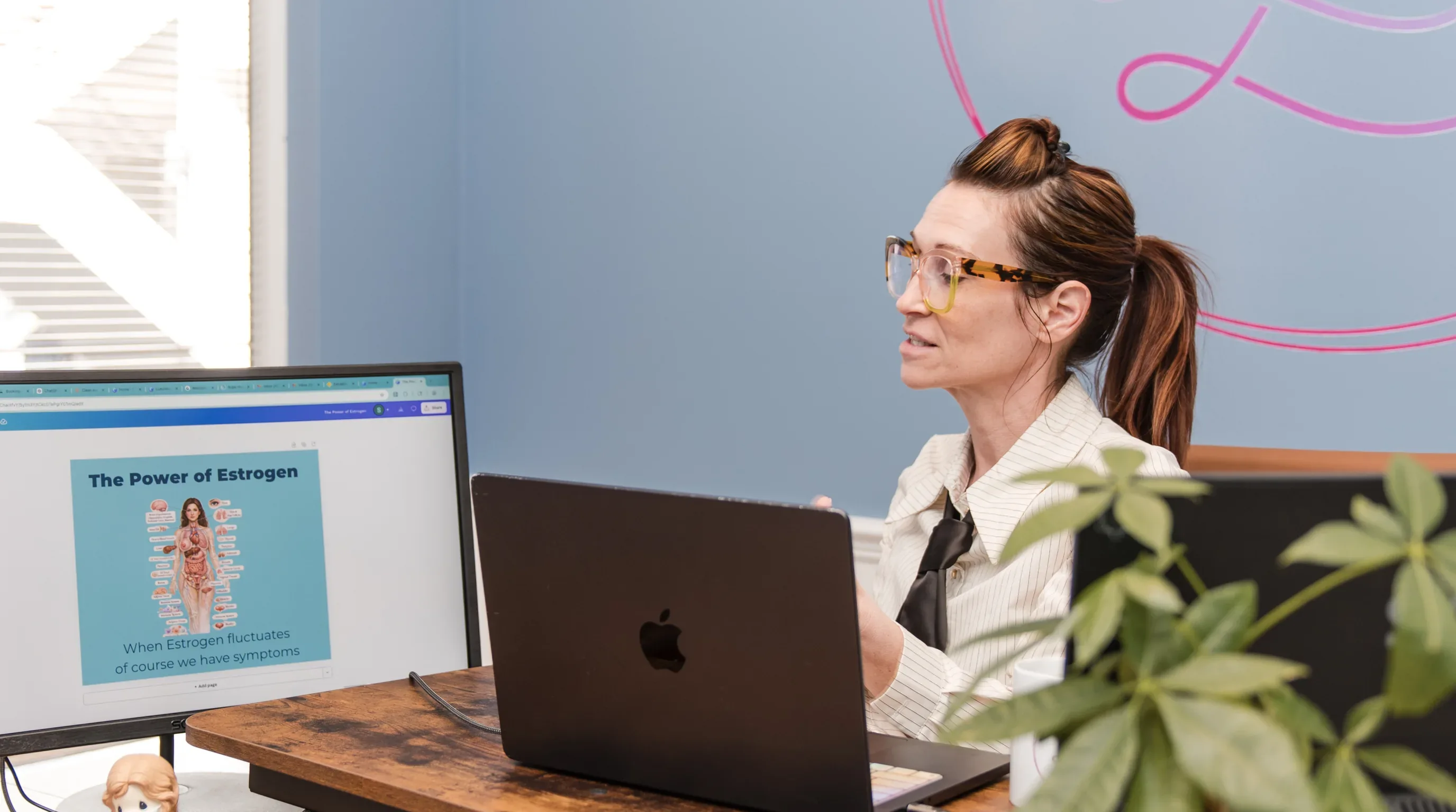 Dr. Sarah presenting The Power of Estrogen slide at her desk
