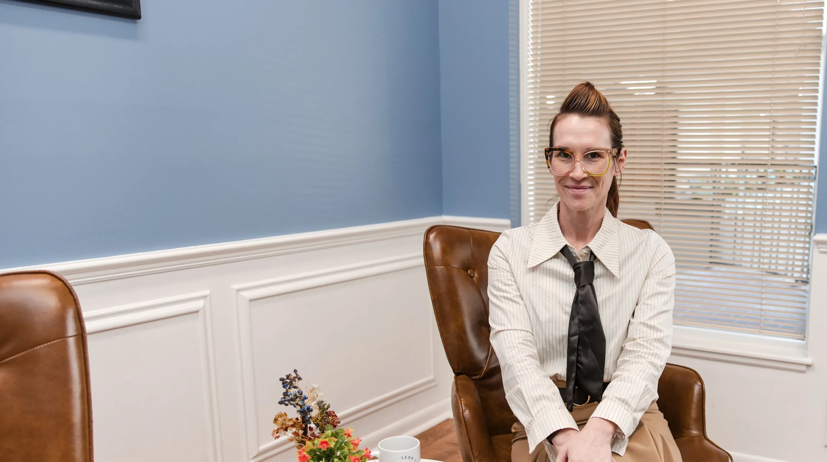 Dr. Sarah Secor-Jones seated in her office at Lesh Lifestyle