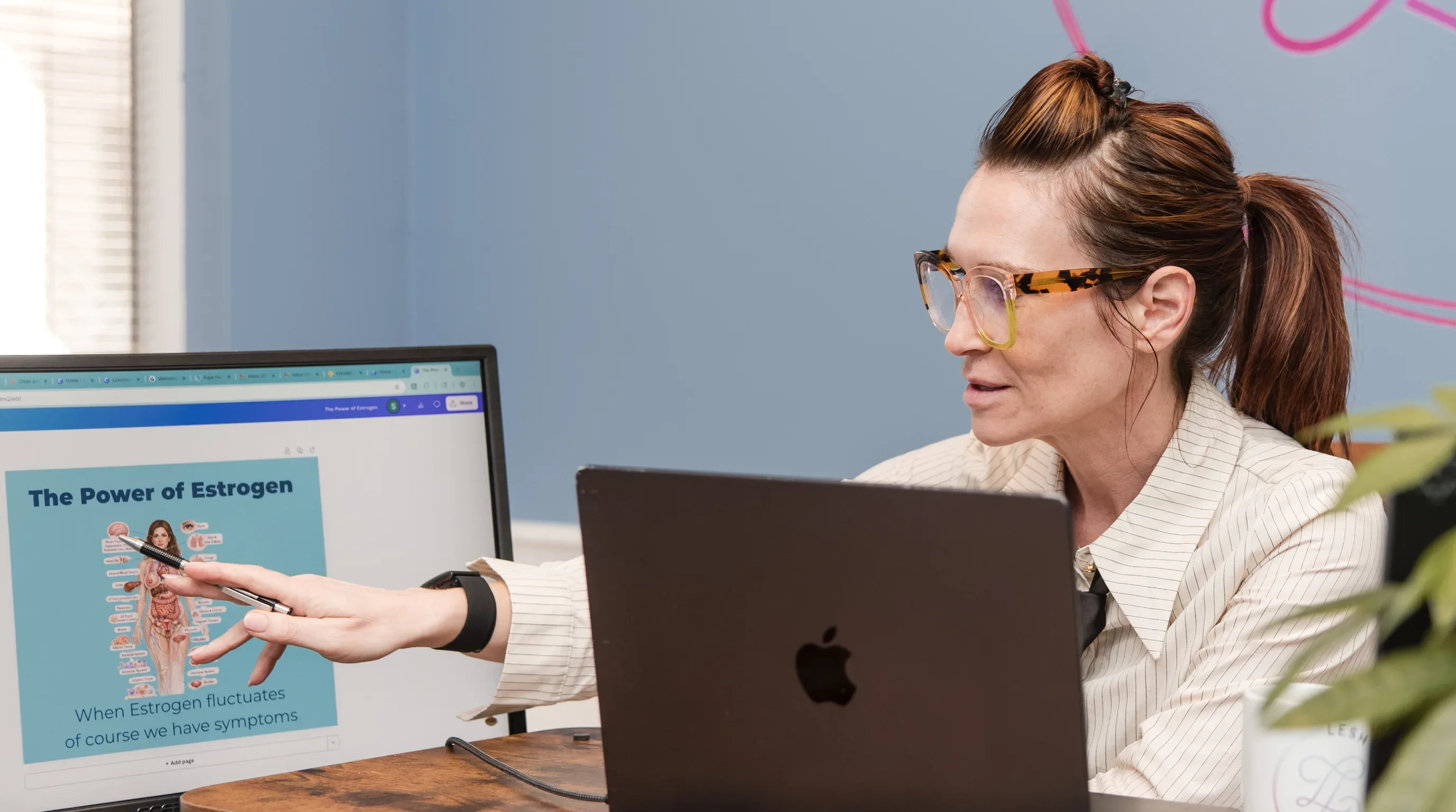 Dr. Sarah reviewing a menopause education slide at her desk