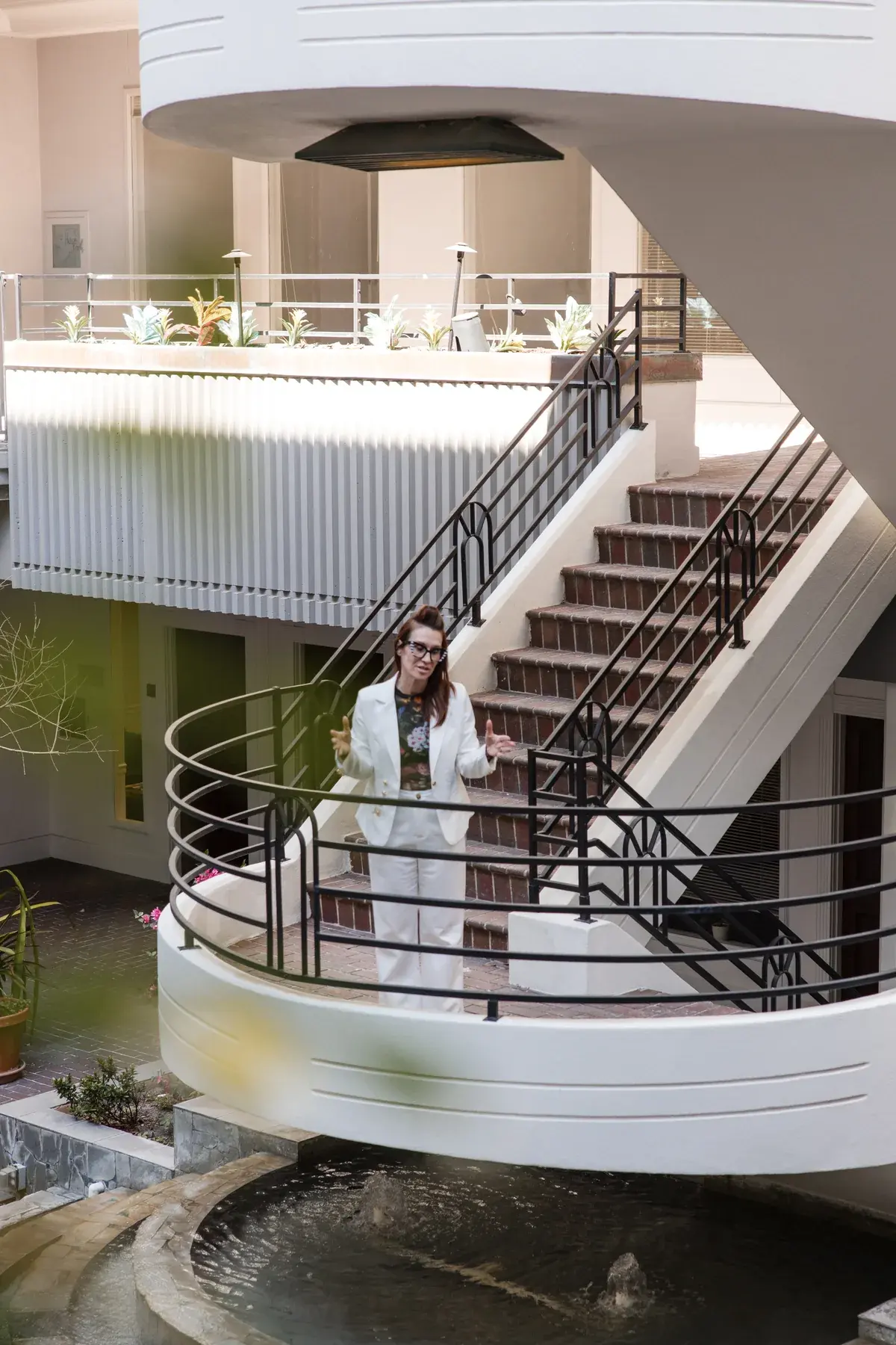 Dr. Sarah Secor-Jones on the atrium staircase outside the Lesh Lifestyle office in downtown Sarasota